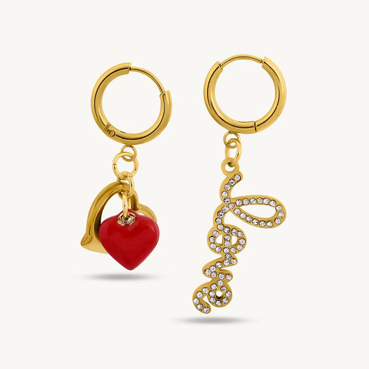 Gold hoop earrings with heart and curly design charms on a white background