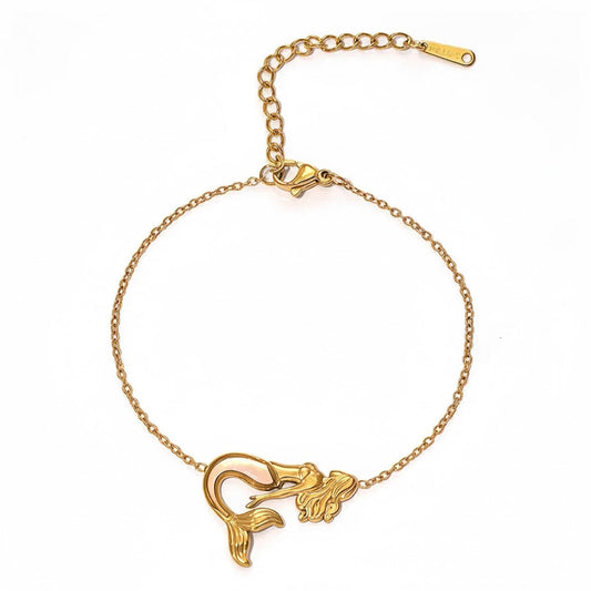 Gold bracelet with a mermaid design on a white background